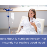 A smiling woman receiving IV nutrition therapy, looking relaxed and energized in a clinic setting.
