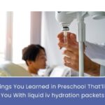 A glass of water with Liquid IV hydration packets, emphasizing the importance of staying hydrated.